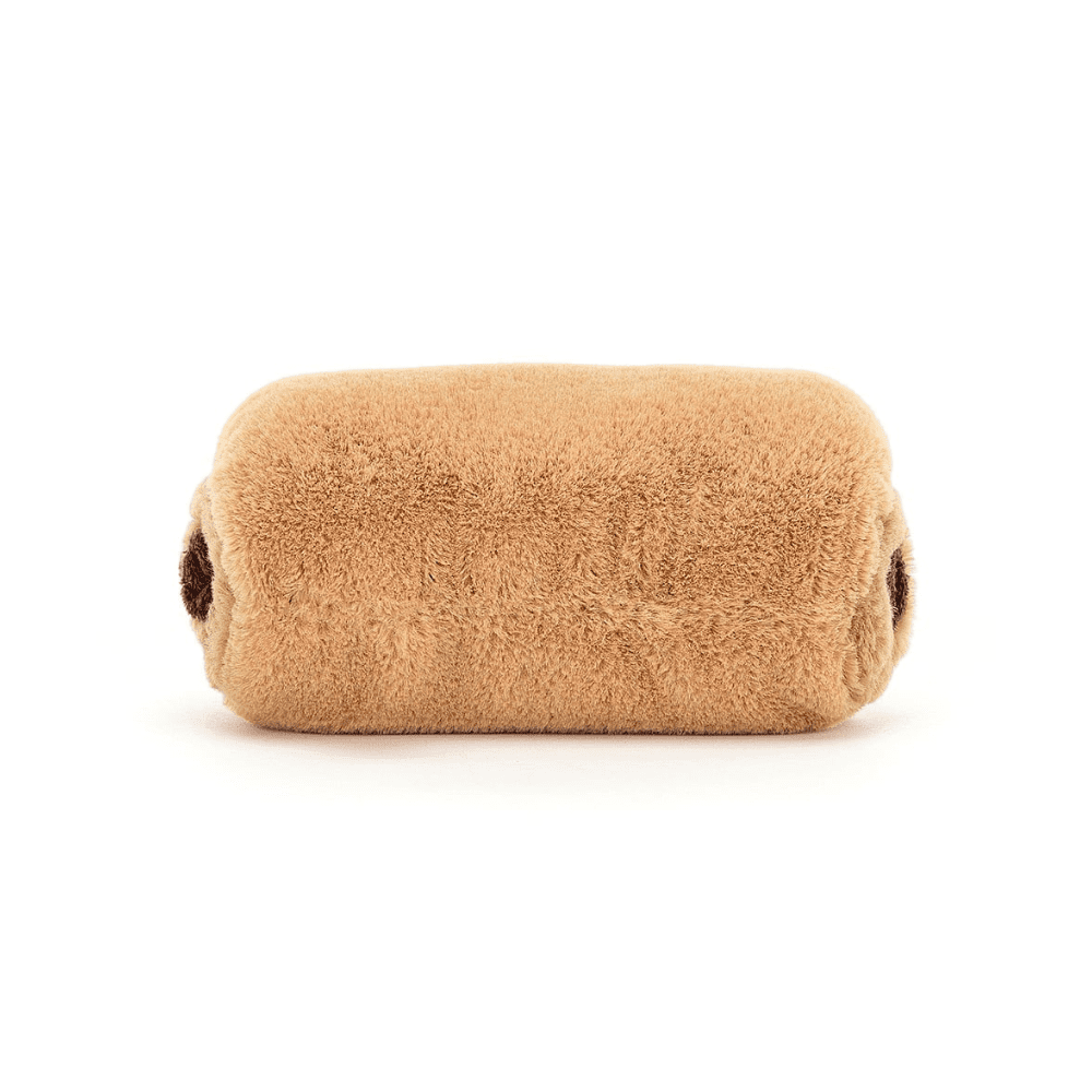 peluche en forme de pain au chocolat sur fond blanc